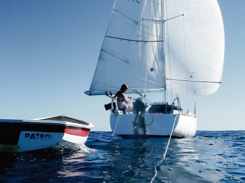 Yacht and dingy in open water