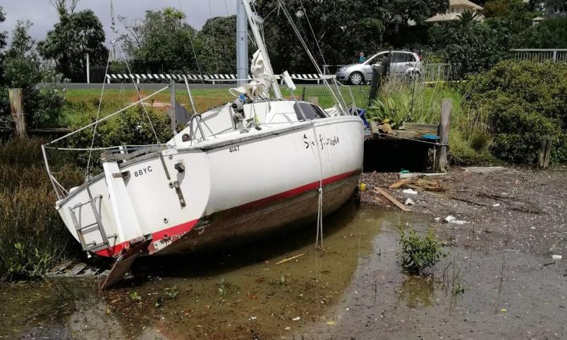 A boat was stranded on Milford Beach during the downpour. 